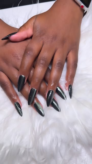 Dark green chrome stiletto acrylic nails on dark skin tone hands