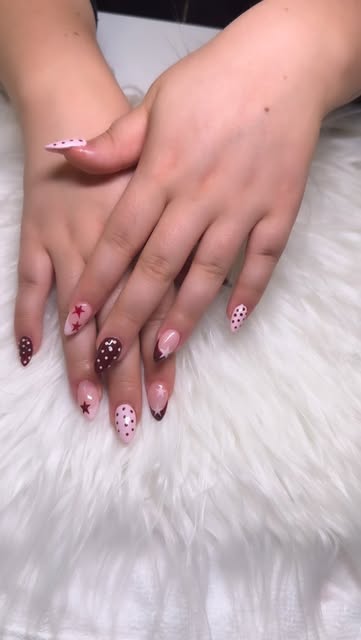 Almond-shaped nails with pink and brown star and polka dot nail art