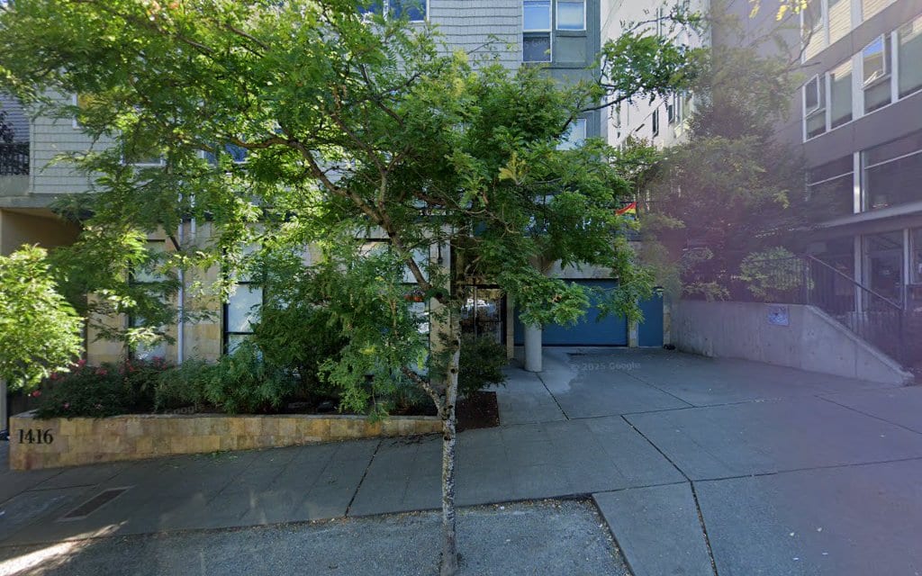 Street-level exterior of a Seattle building entrance at address 1416